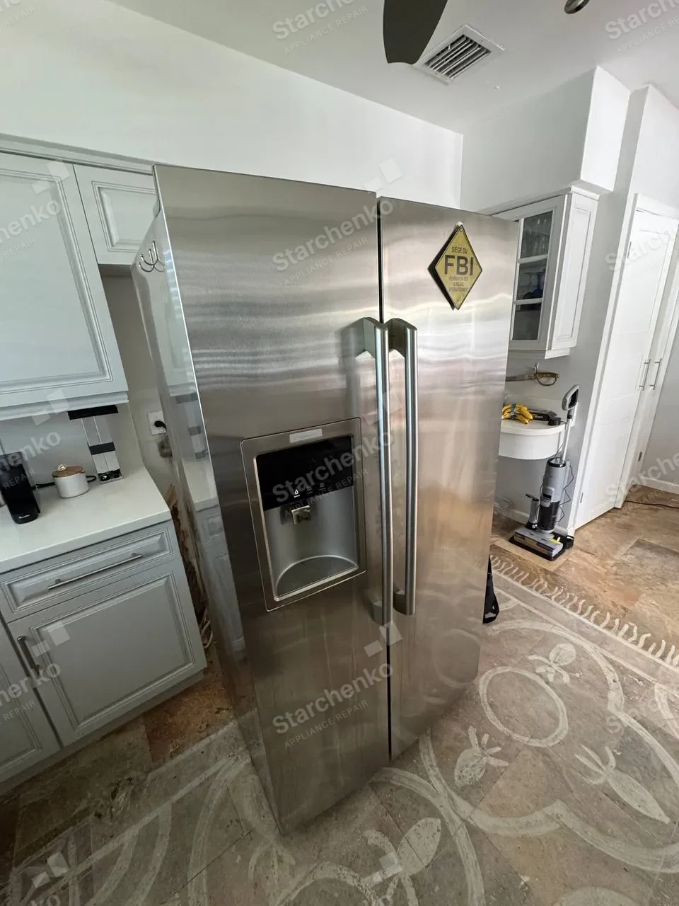 Stainless Electrolux side-by-side refrigerator with a water and ice dispenser in a bright kitchen
