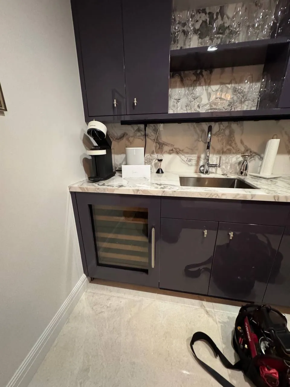 Sub-Zero wine cooler built into dark cabinetry during a door gasket replacement