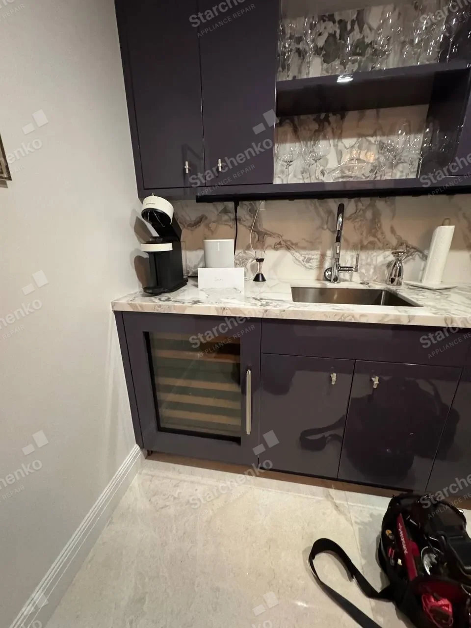 Sub-Zero wine cooler built into dark cabinetry during a door gasket replacement