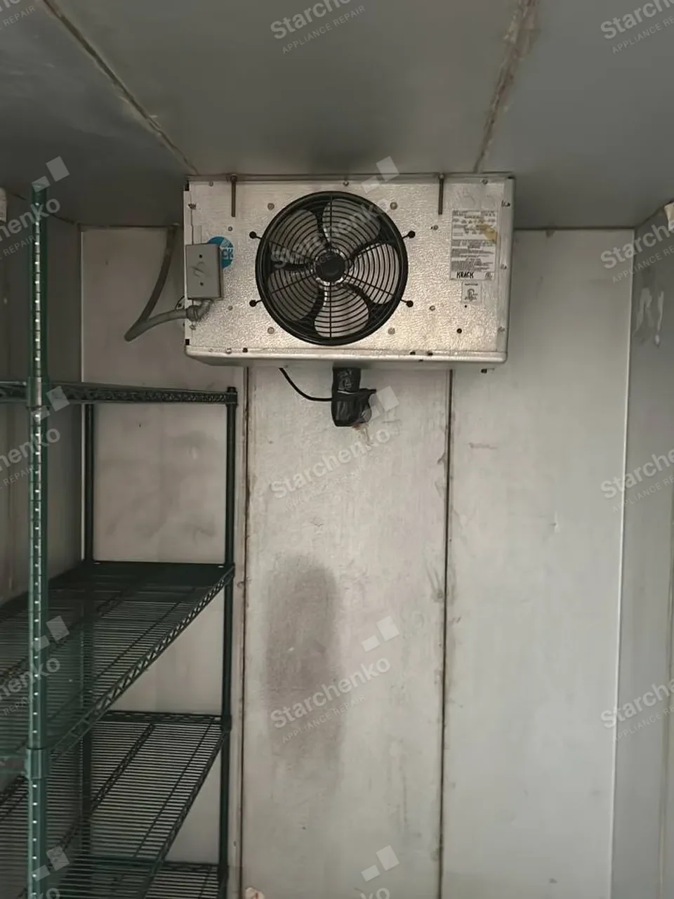 Walk-in refrigerator with the ceiling evaporator and fan visible