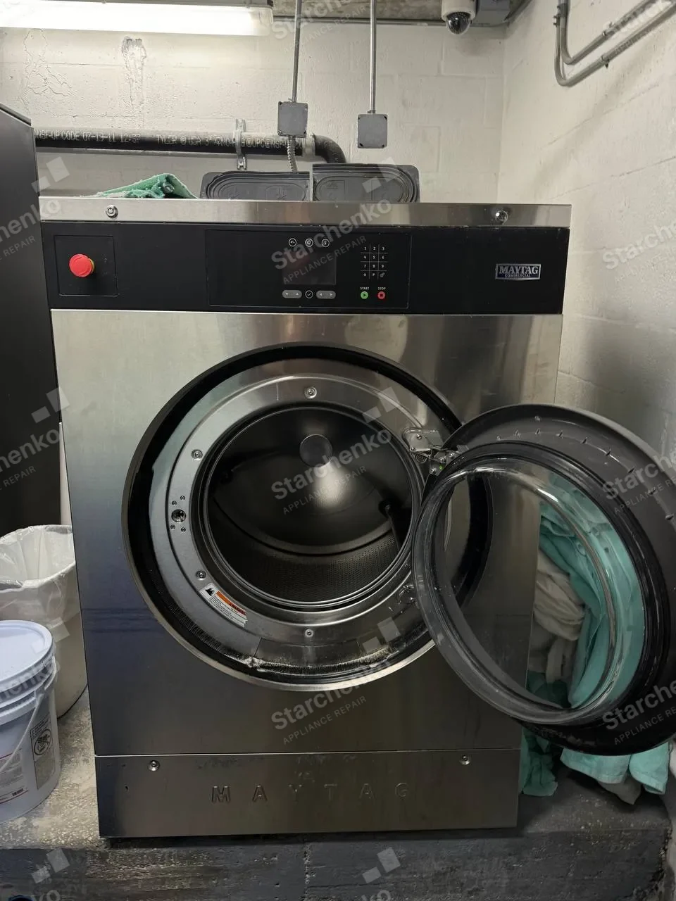 Maytag Commercial washer with its door open during a door lock replacement