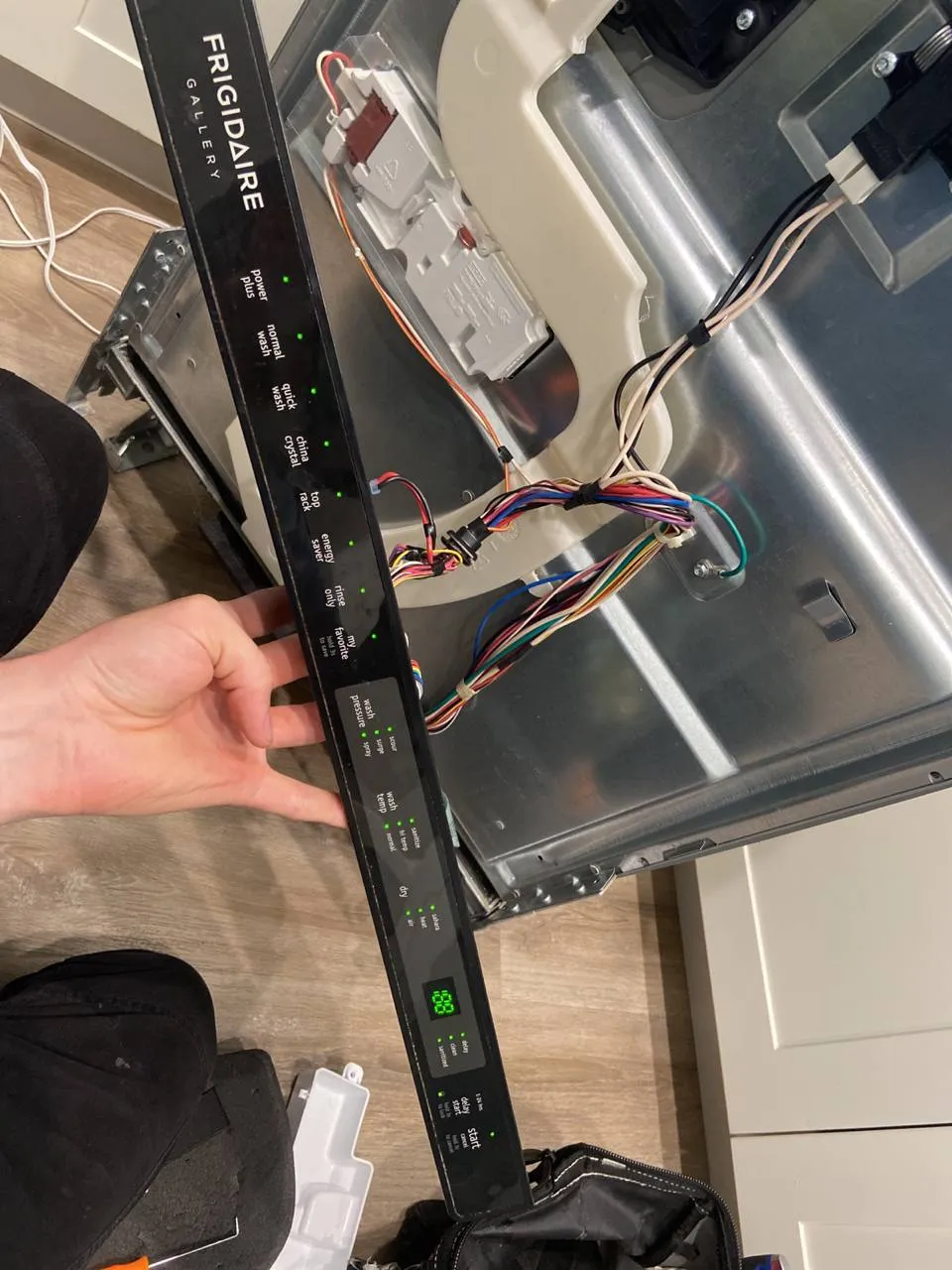 Frigidaire dishwasher control panel removed with its wiring exposed