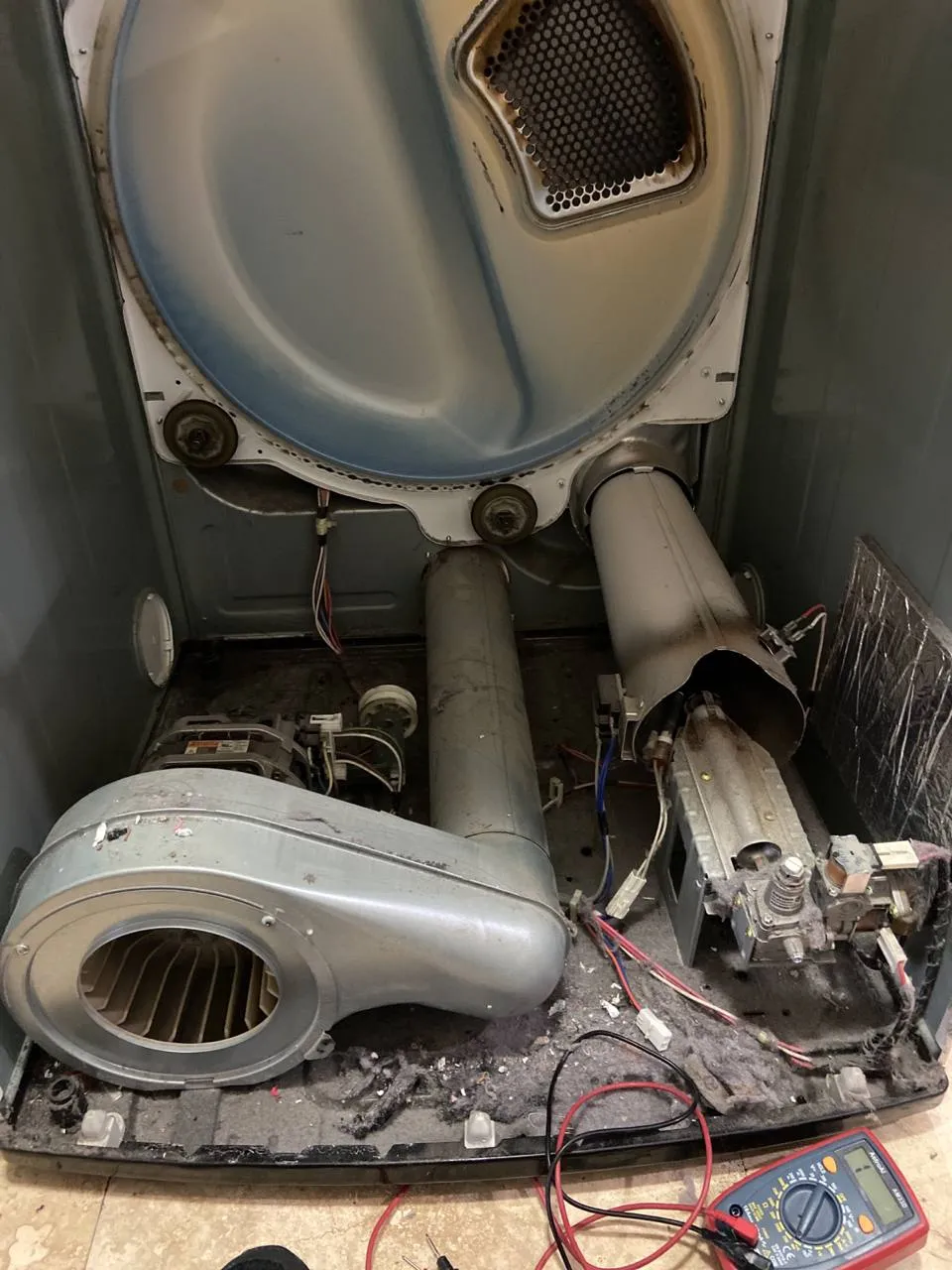 Electrolux dryer opened to expose the drum, blower and flame sensor