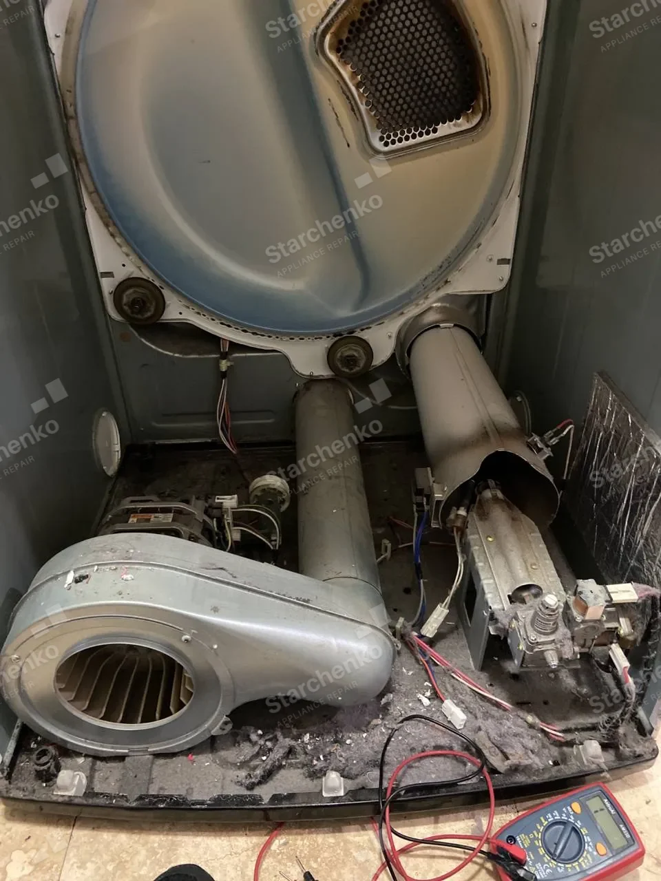 Electrolux dryer opened to expose the drum, blower and flame sensor