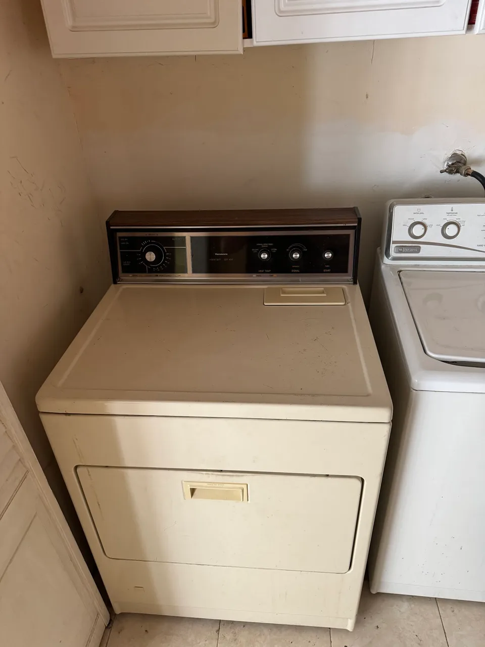 Vintage Kenmore dryer beside a top-load washer in a laundry room