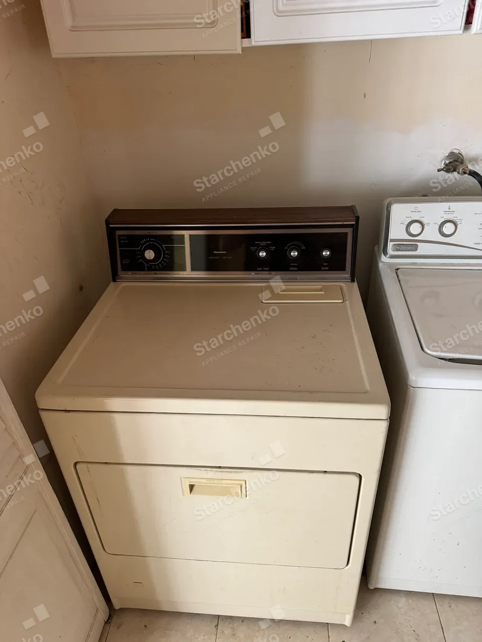 Vintage Kenmore dryer beside a top-load washer in a laundry room