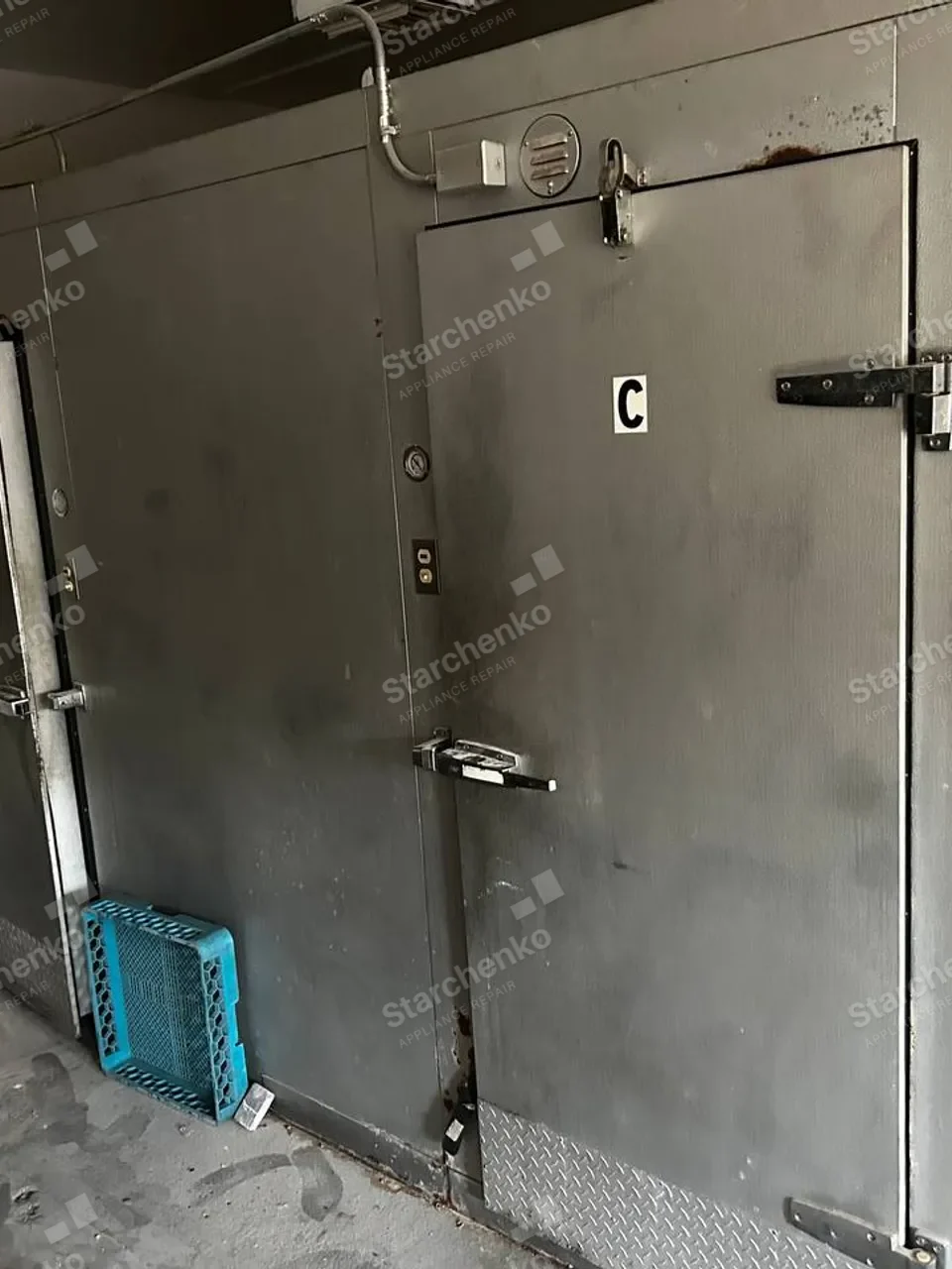 Walk-in freezer with its insulated door and wall panels visible