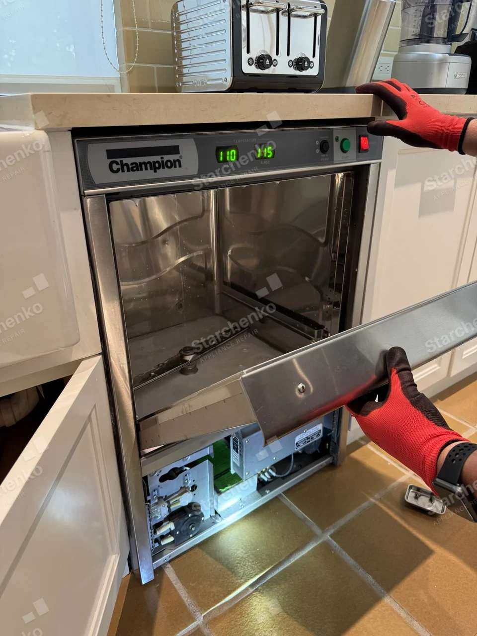 Champion undercounter commercial dishwasher with the door open and the lower front panel being removed