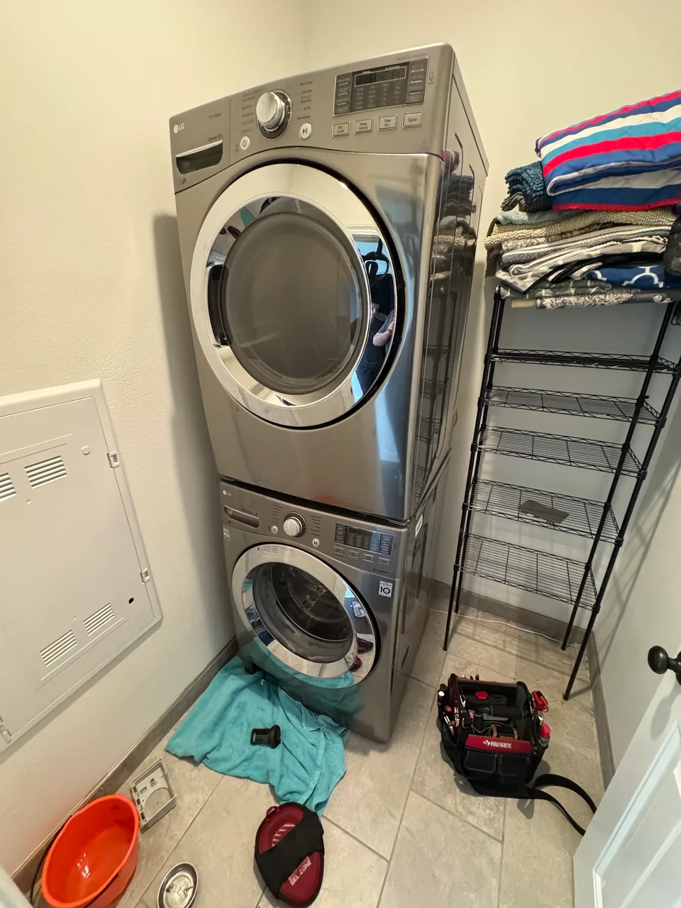 Stacked LG washer and dryer during a repair visit