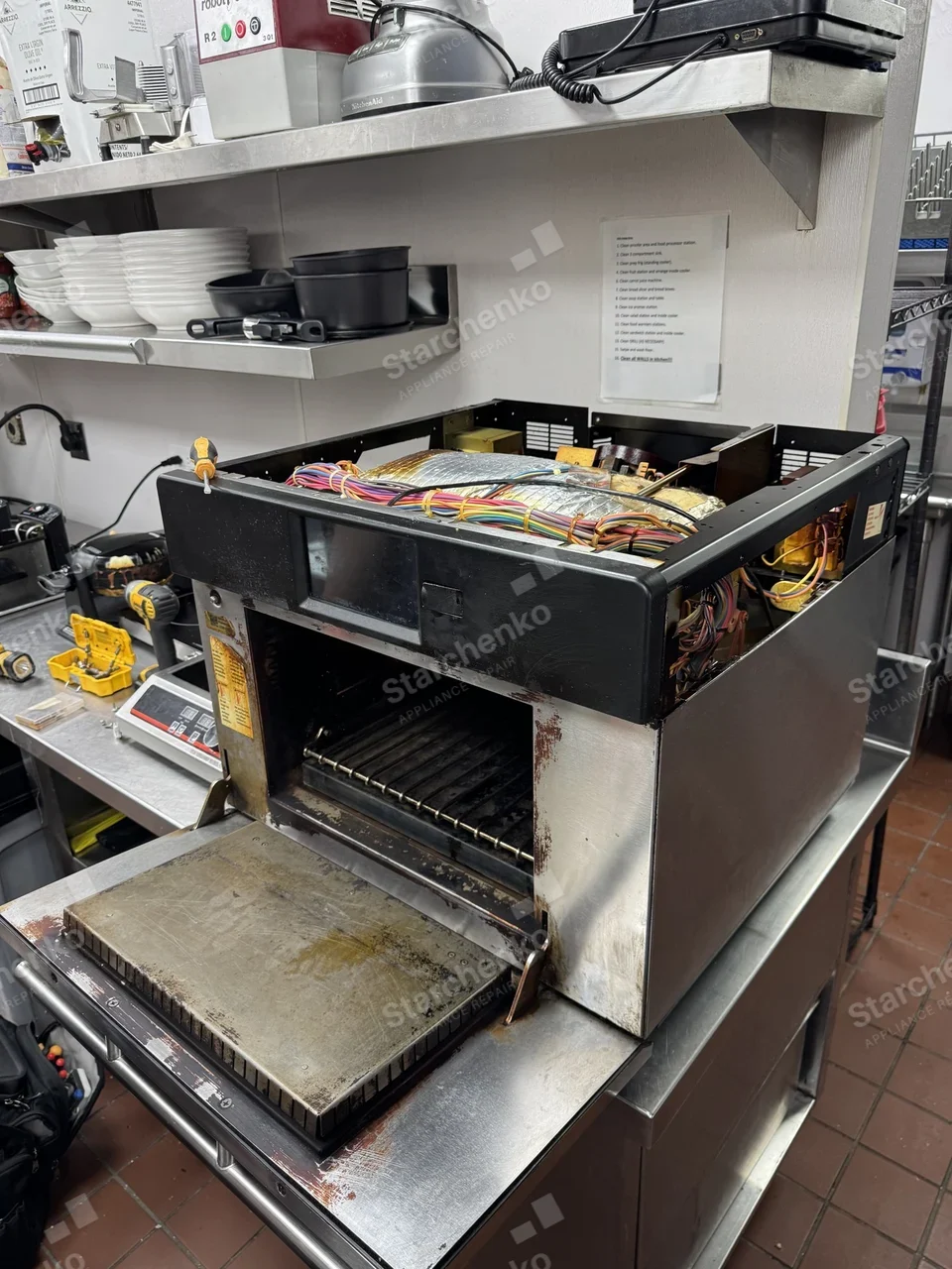TurboChef speed oven with the top cover removed and its wiring harness exposed on a restaurant counter
