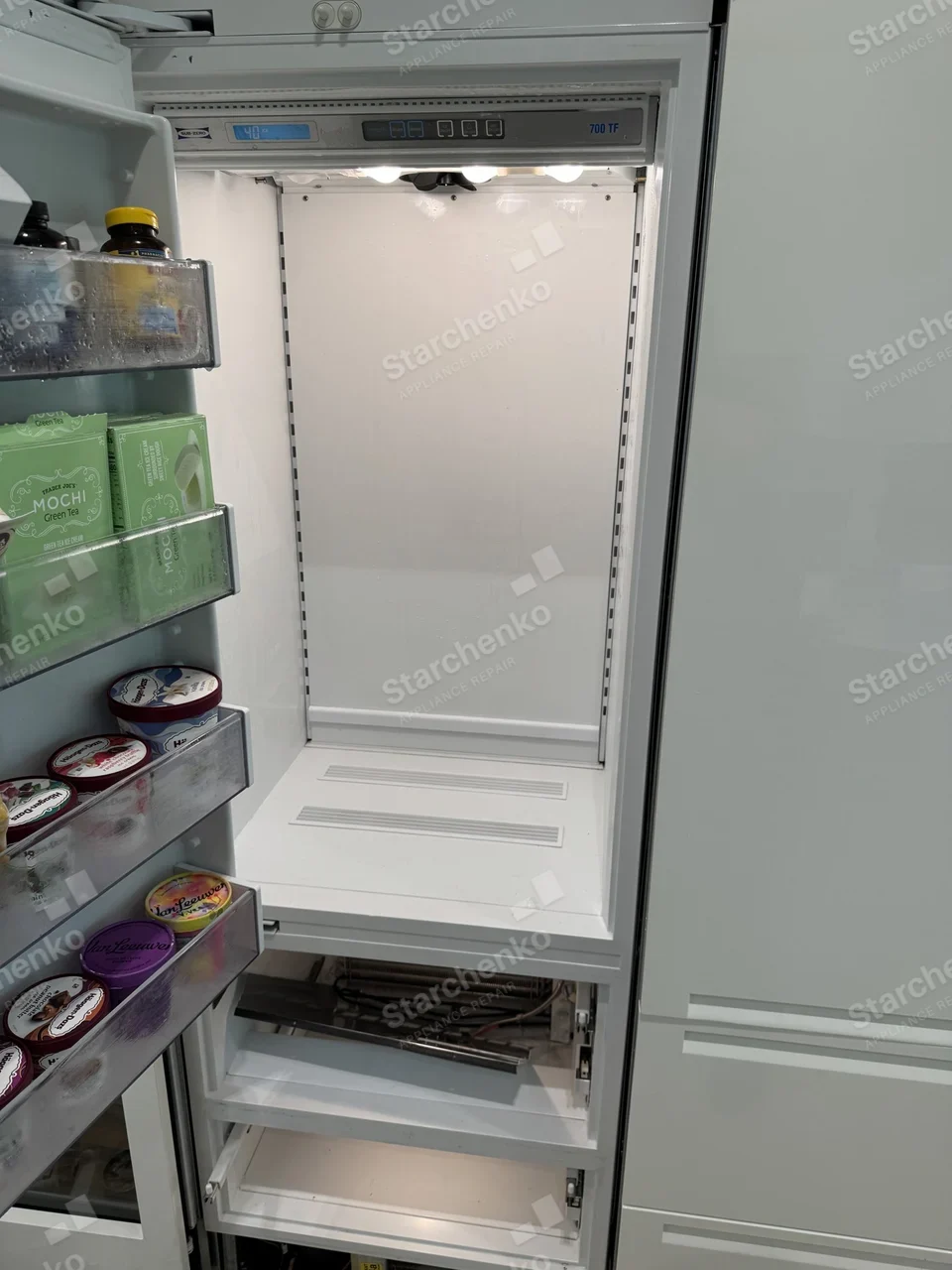 Sub-Zero built-in freezer with the lower drawers removed and the evaporator exposed