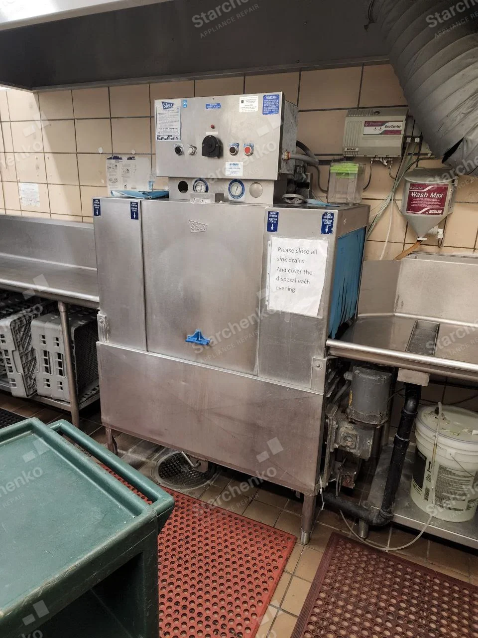 Large stainless Stero conveyor dishwasher with control panel beside dish racks.