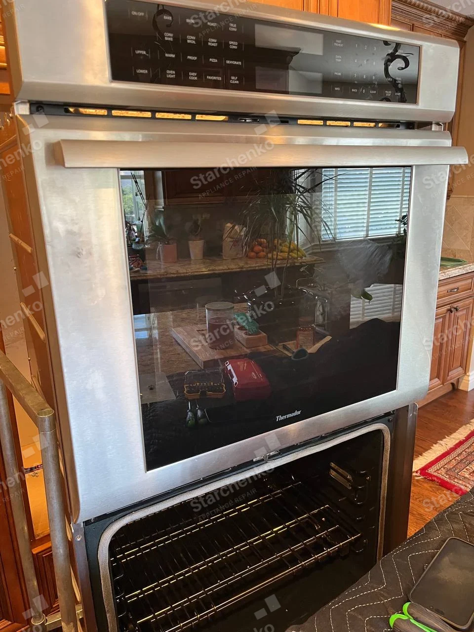 Thermador repair: Double built-in wall oven removed onto stand, lower oven open.