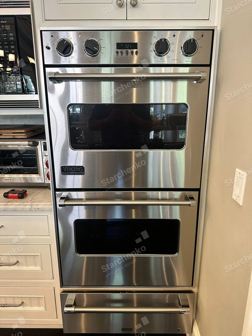 VIKING badge on upper main built-in oven door, Wolf appliance to the left is separate.