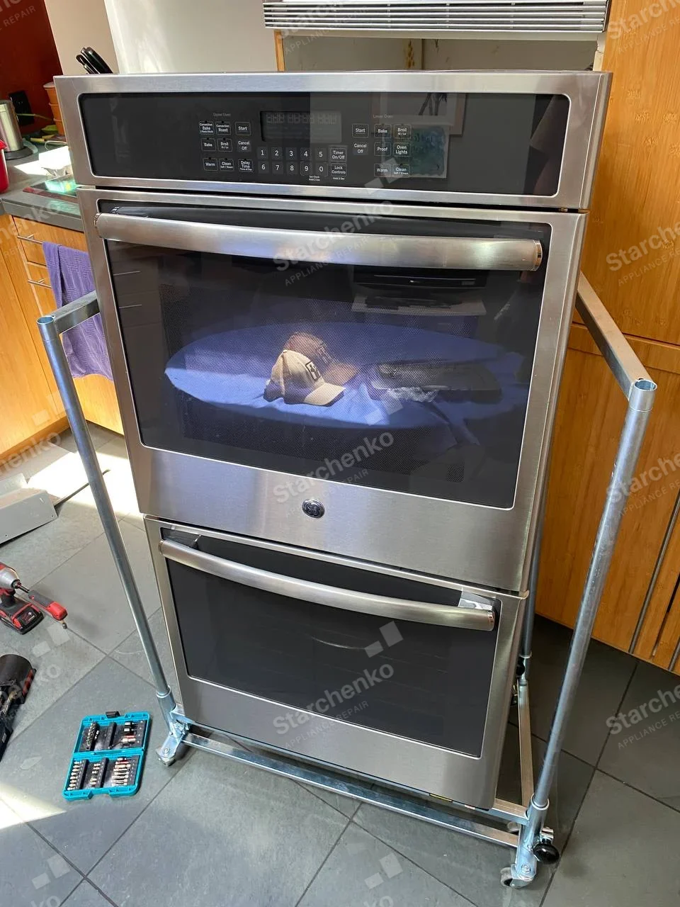 GE repair: Double built-in oven removed onto wheeled service dolly.