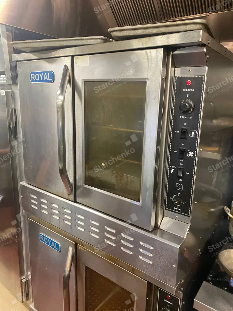 Stacked Royal stainless commercial convection ovens with side thermostat and fan controls.