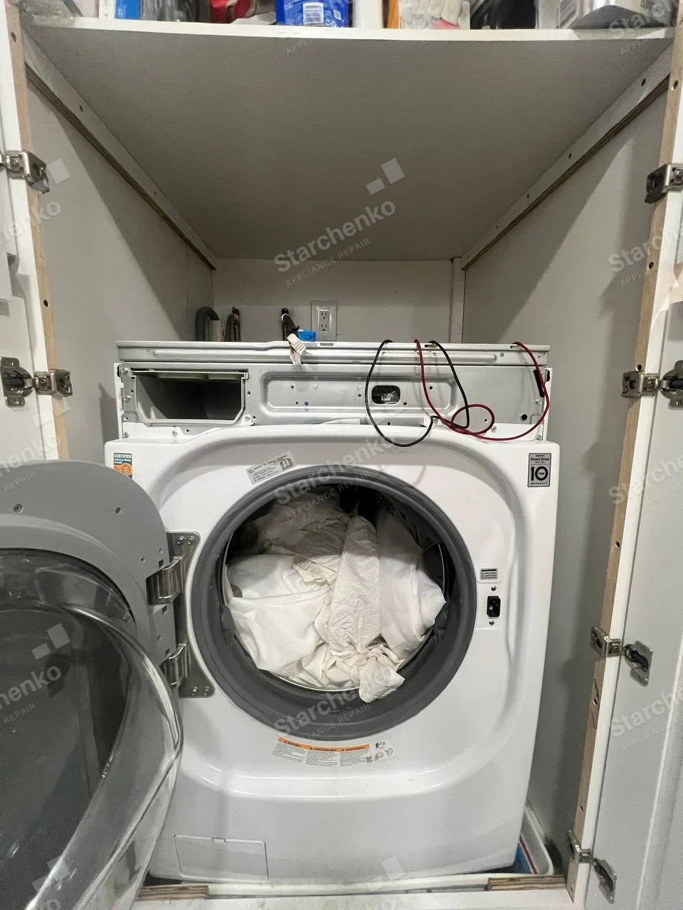 Kenmore repair: Front-load washing machine door open and control fascia removed, warranty and Direct Drive decals do not state full brand.