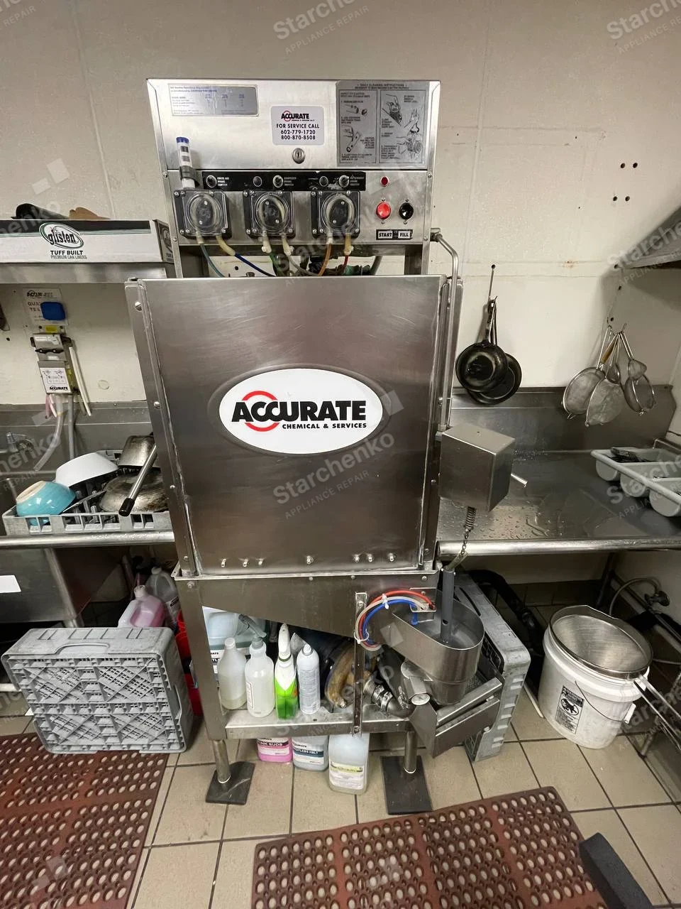 Meiko repair: Tall stainless commercial dishwasher with front panel and three chemical dosing pumps above.