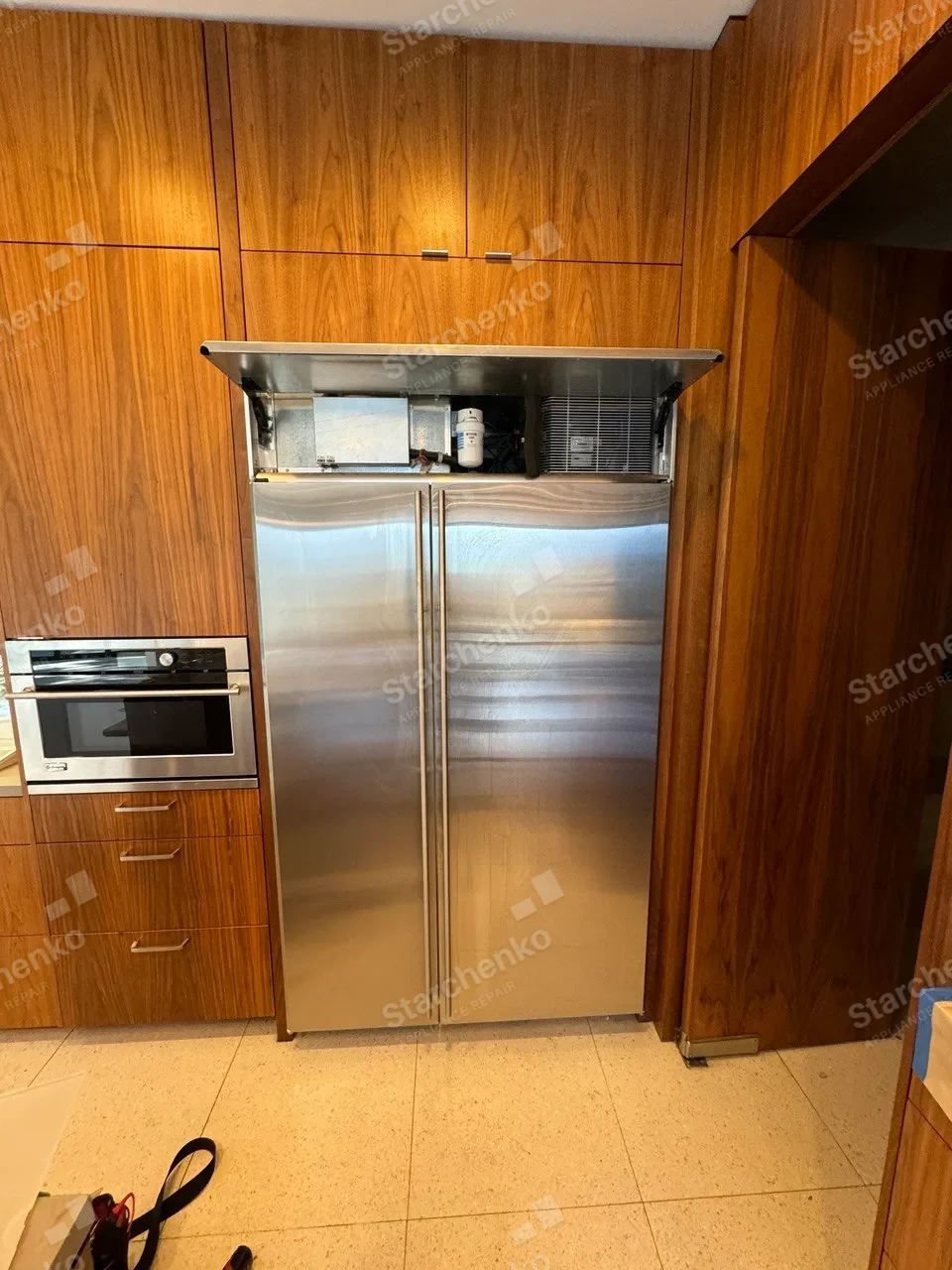 Stainless Thermador side-by-side refrigerator in a walnut kitchen
