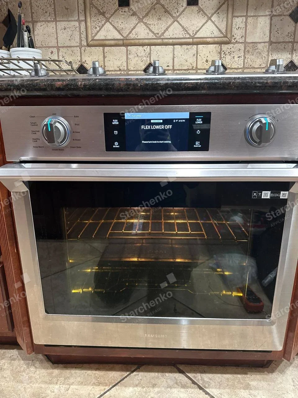 SAMSUNG name centered below oven window on gas range, cooktop knobs above, Flex lower oven display.