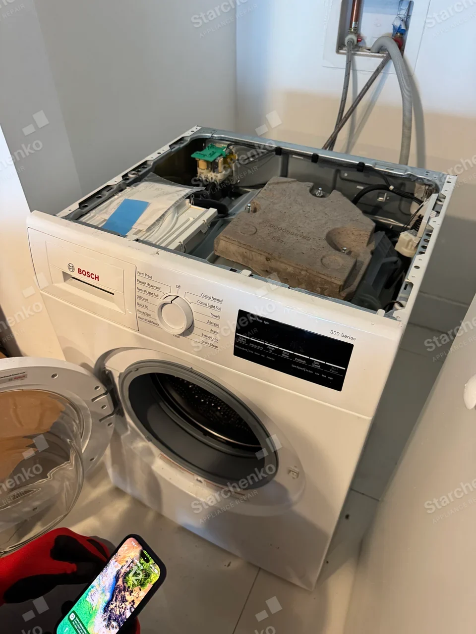 BOSCH wordmark on the front control fascia of a top-open front-load washer.
