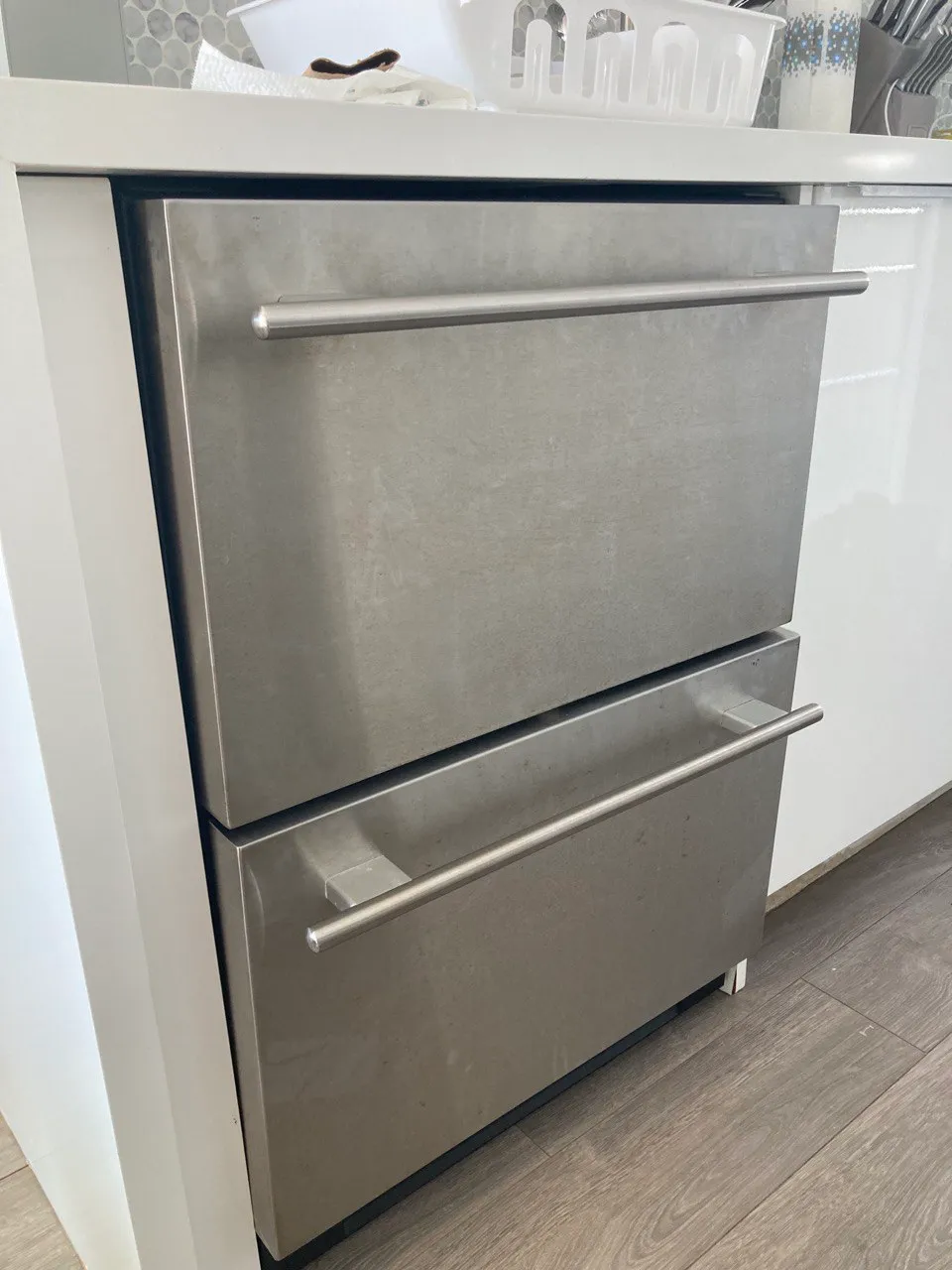 Two stainless under-counter refrigerator drawers built into a kitchen island