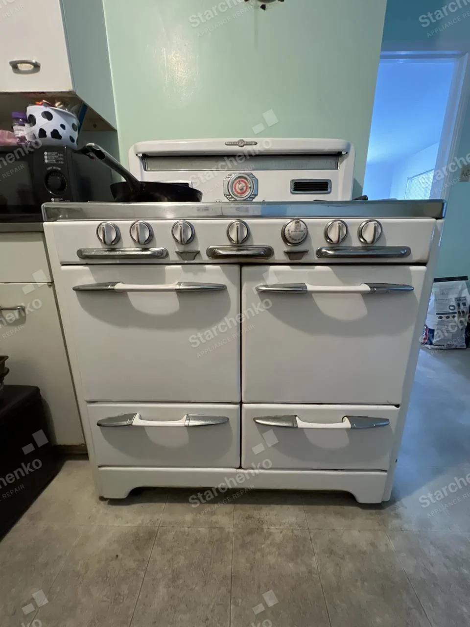 KitchenAid repair: Vintage white gas range with two oven doors, lower drawers and front control knobs.