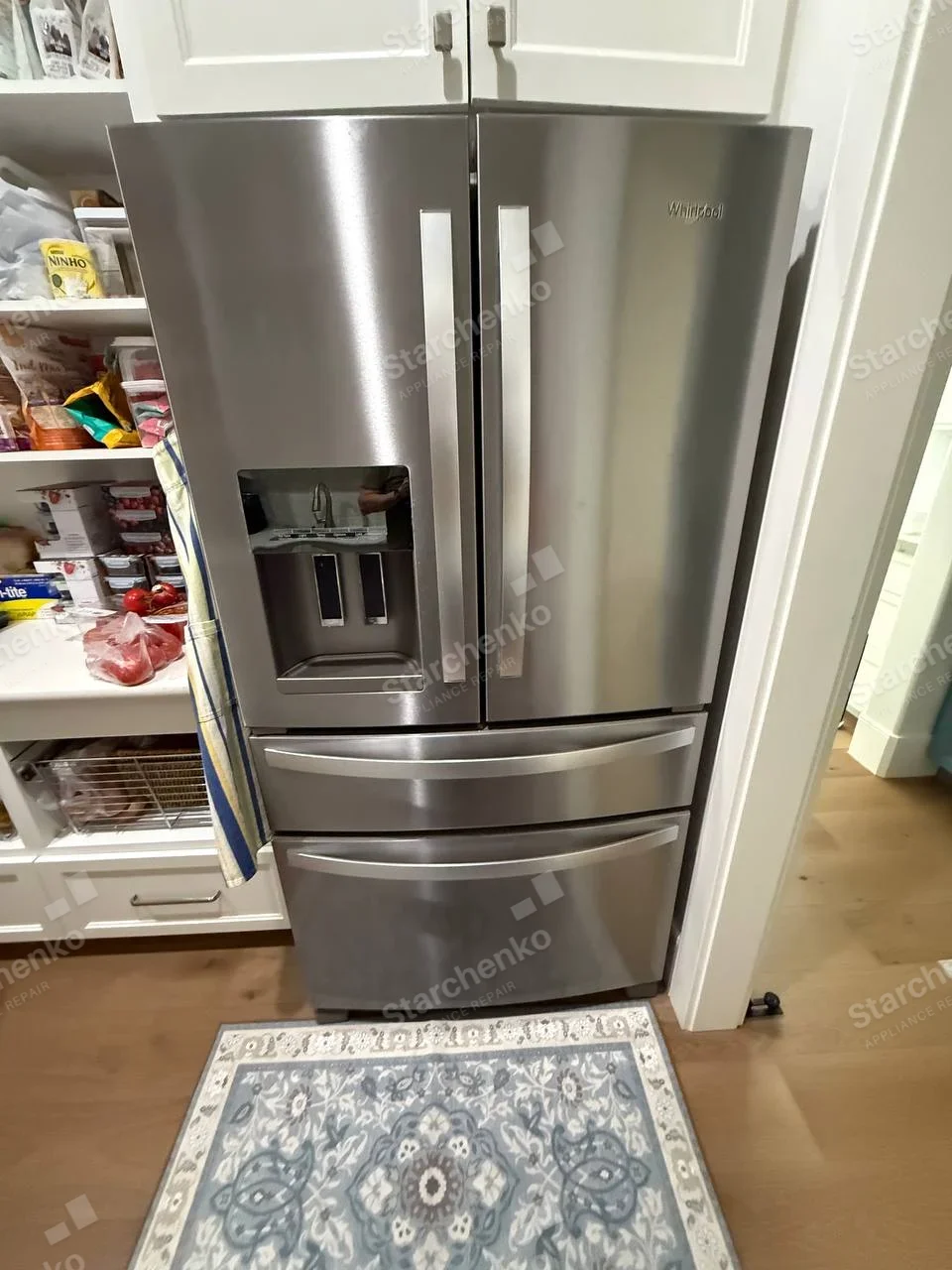 Whirlpool name on upper-right door of French-door refrigerator with two lower drawers.