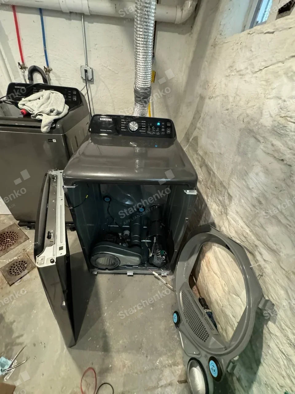 Samsung repair: Dryer front panel removed, showing blower, motor and drum support.