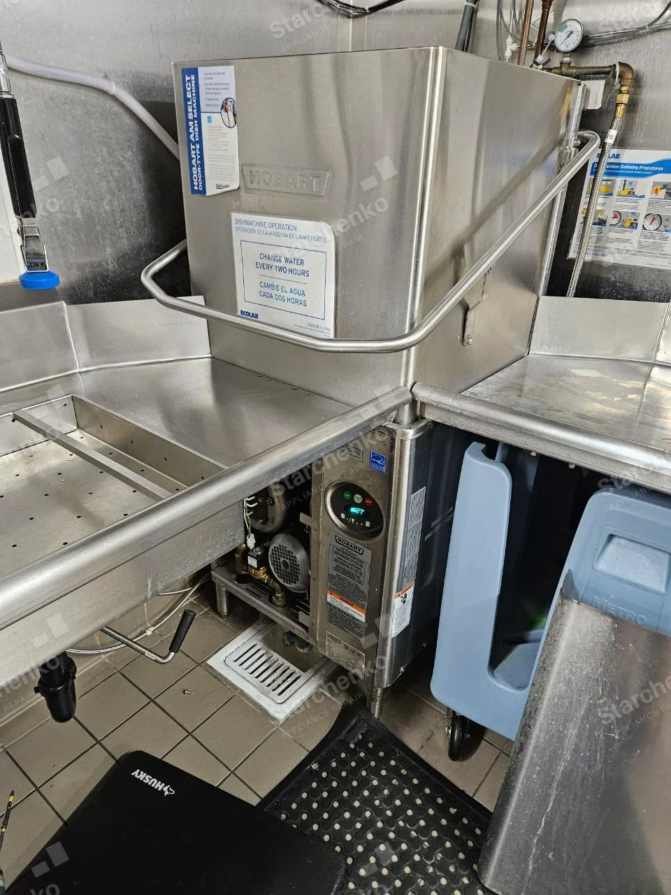 HOBART embossed on upper dishwasher hood and Hobart nameplate on lower control cabinet, stainless wash station.