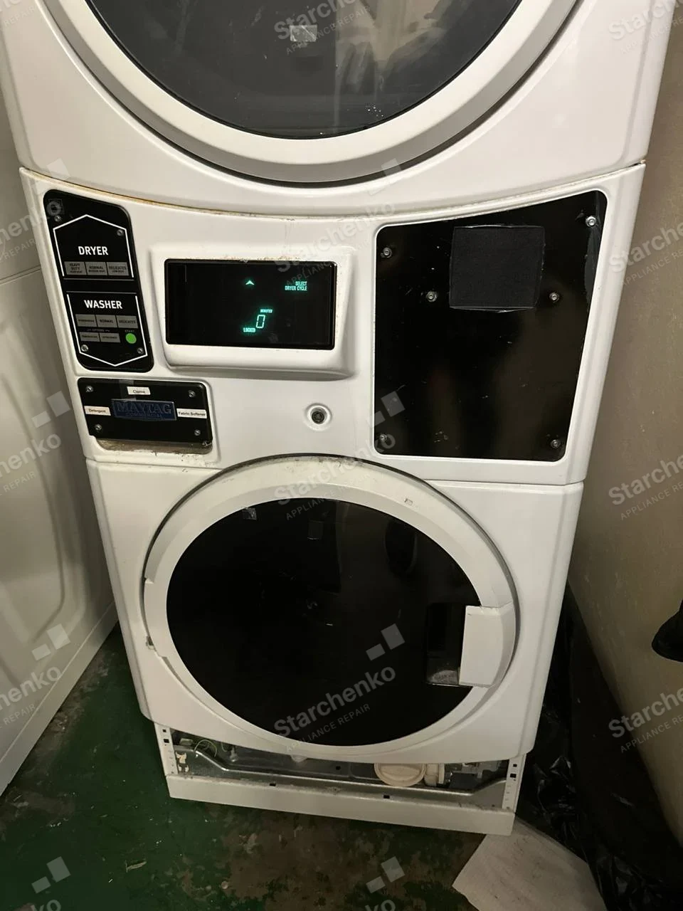 Stacked Maytag commercial dryer and washer with lower washer base access panel removed.