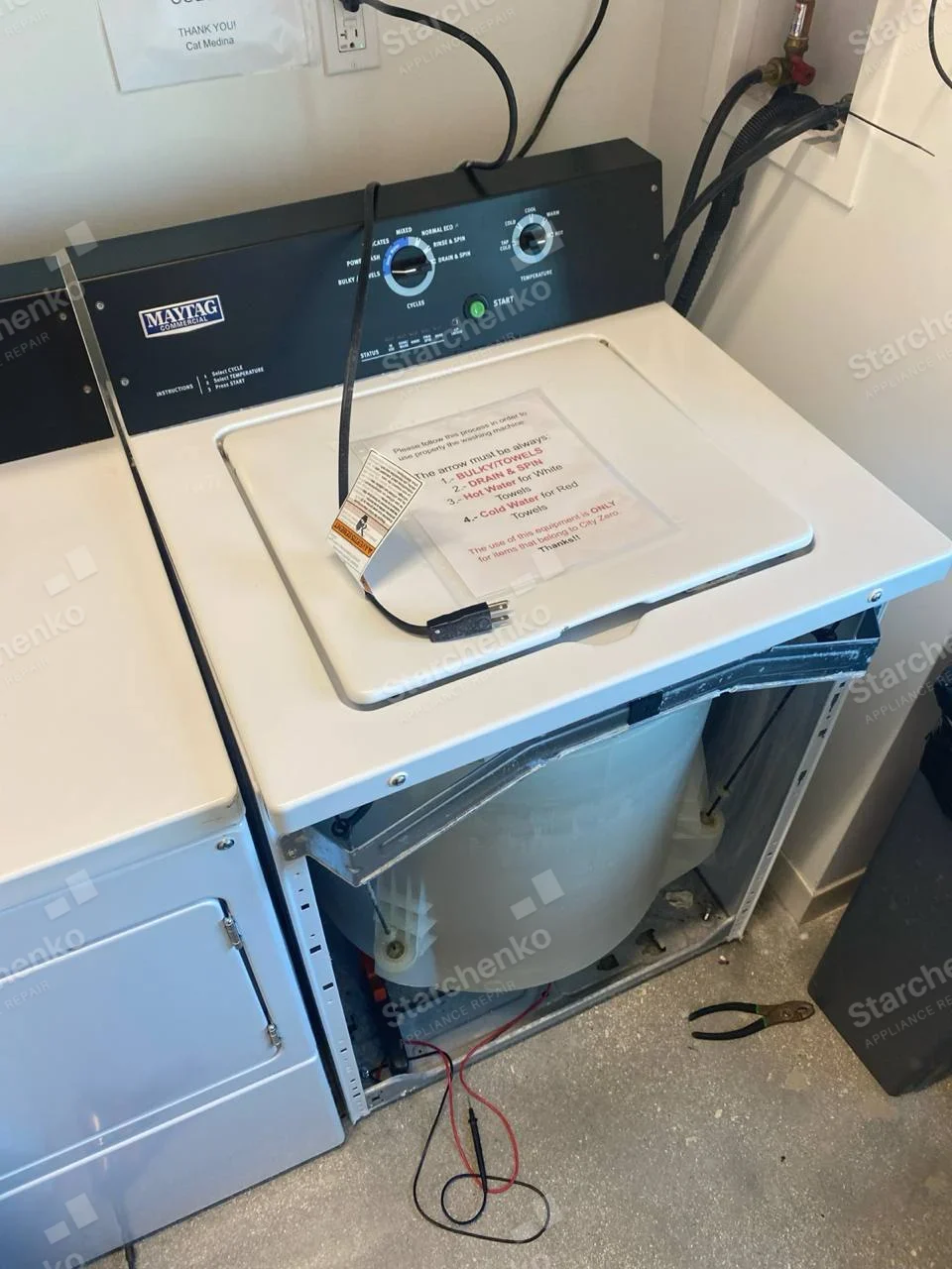 Maytag Commercial badge on rear console, front casing removed exposing wash tub.