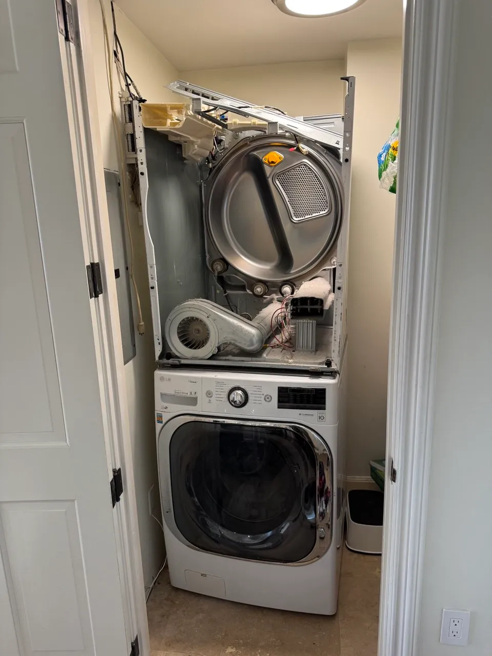 Stacked LG unit with the dryer opened and the blower removed