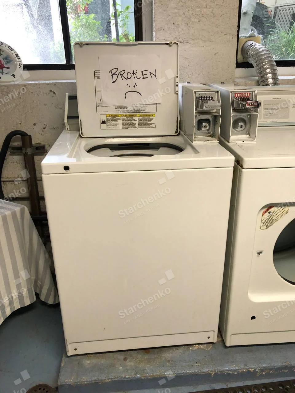 IPSO repair: Left top-load washer has lid open and BROKEN note, coin box nearby, right front-load dryer is separate.