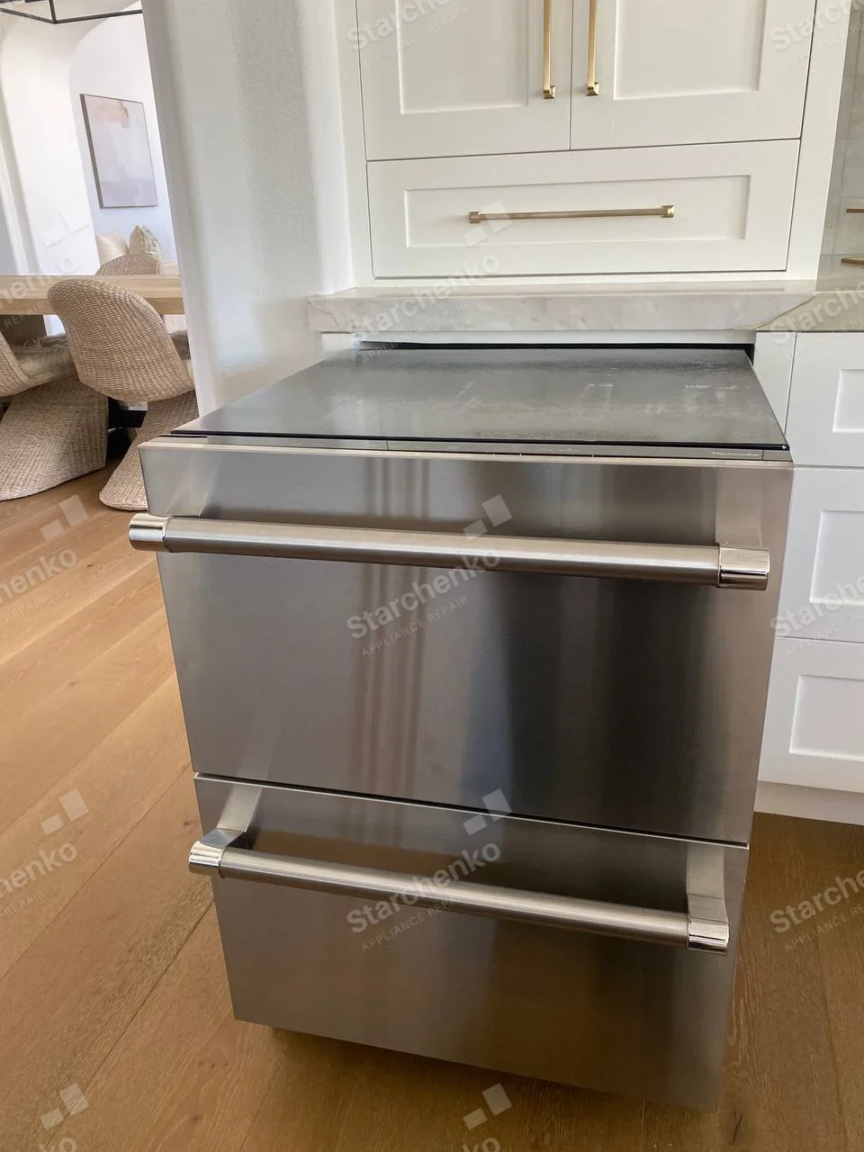 Marvel repair: Two stacked stainless undercounter refrigeration drawers with horizontal handles.