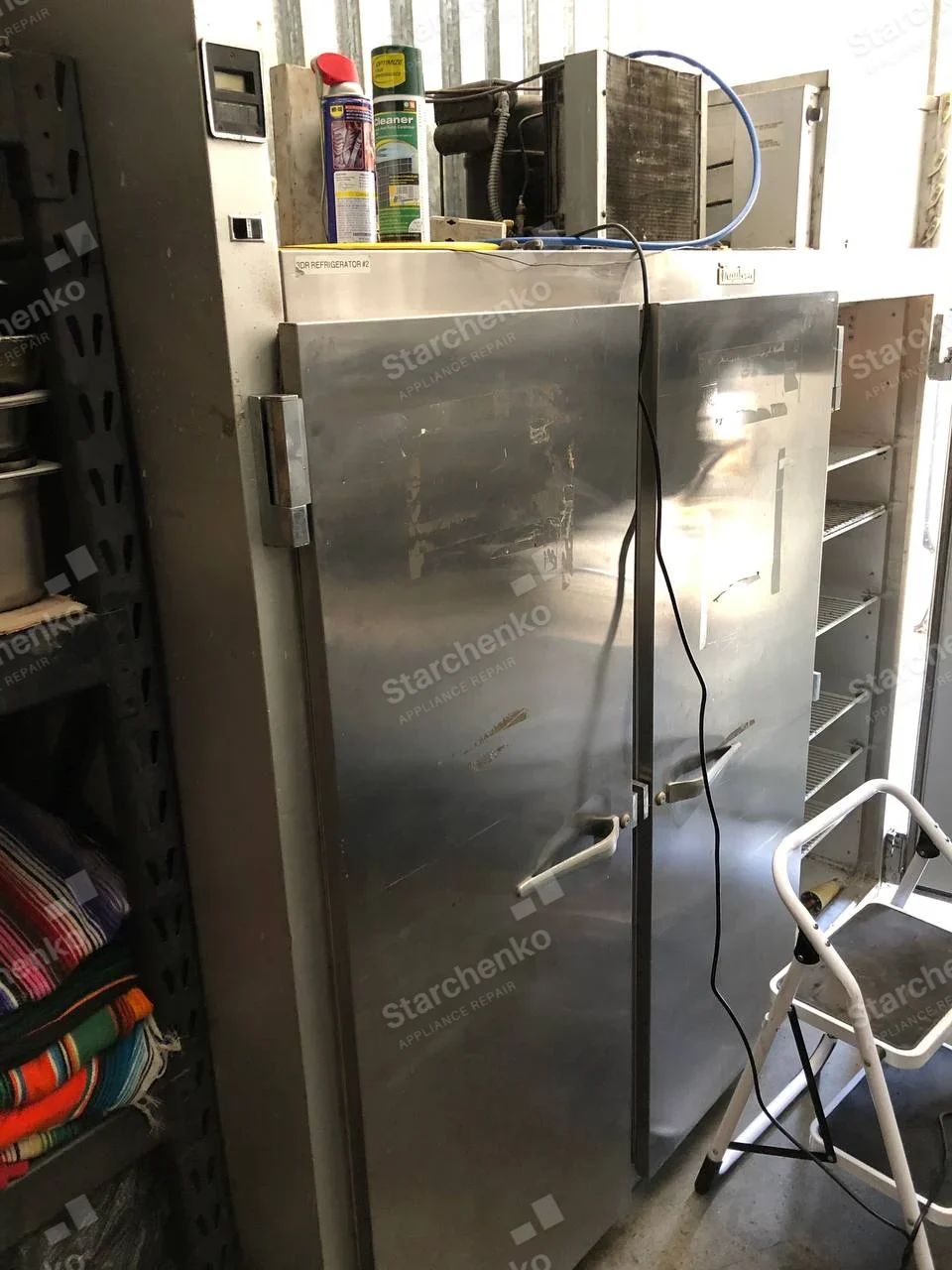 Traulsen repair: Stainless commercial upright refrigerator with open top refrigeration compartment.