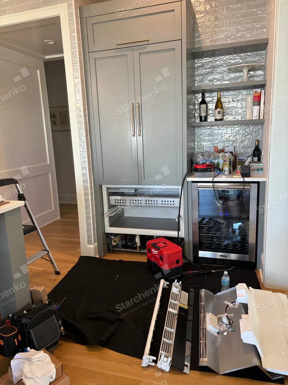 Danby repair: Left undercounter refrigeration drawer with front and lower panels removed and compressor area exposed.