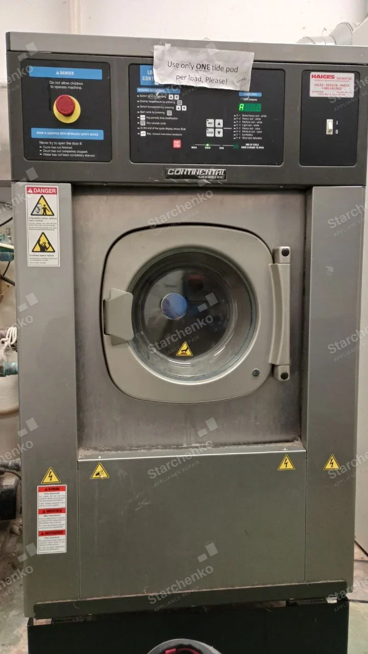 Continental Girbau repair: Continental stainless industrial front-load washer with central door and top control panel.