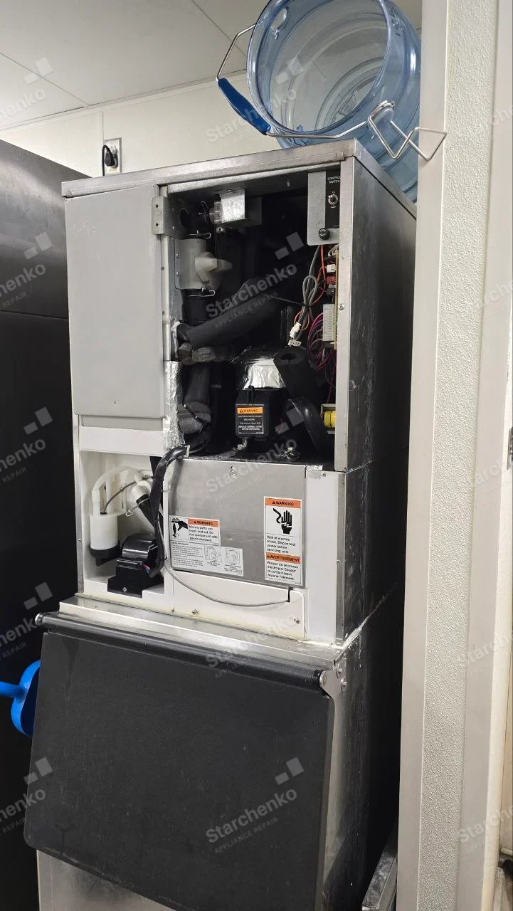 Kold-Draft repair: Large commercial ice machine service panel opened at compressor and water pump assemblies, brand not readable.