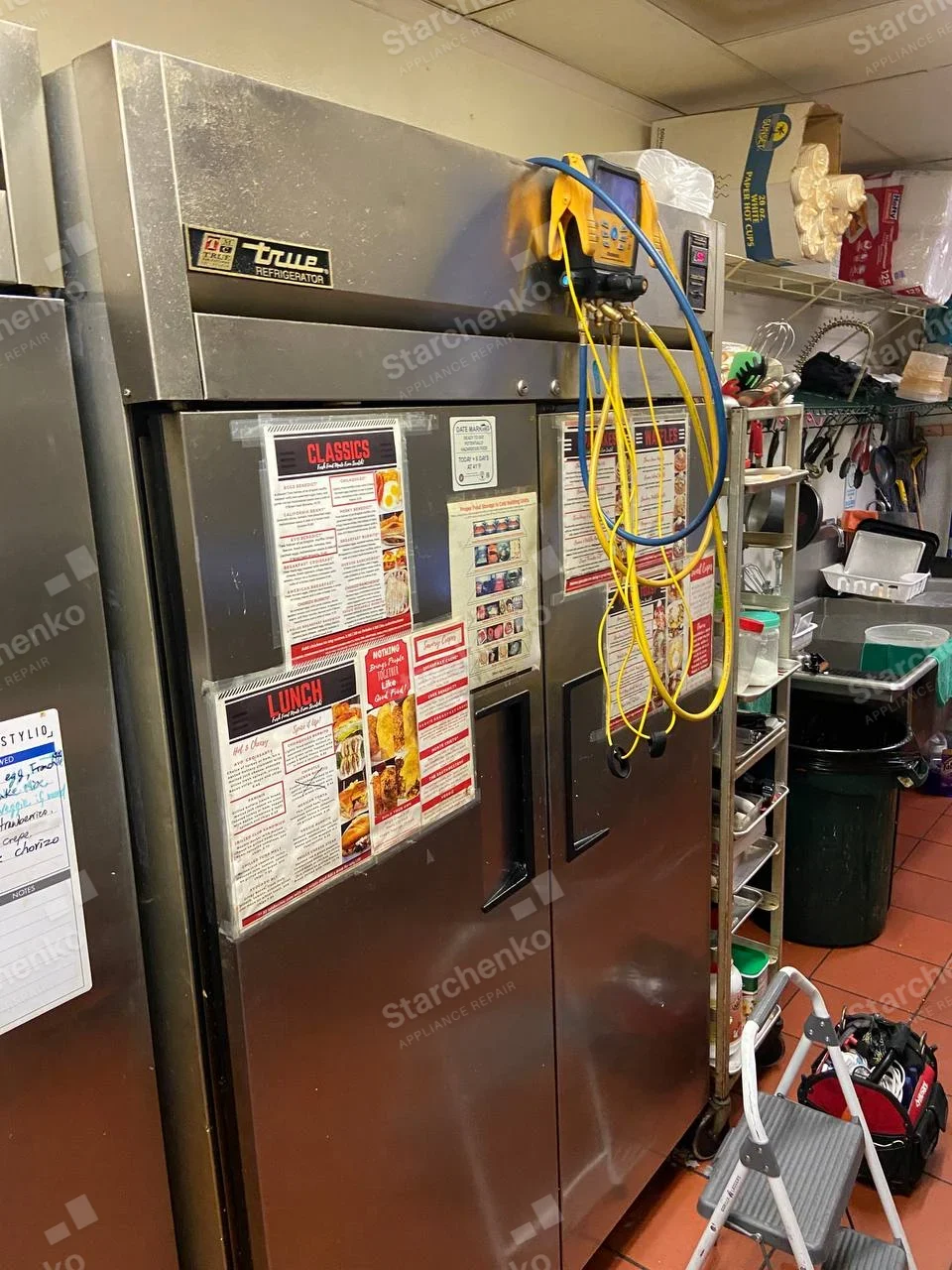True repair: Commercial two-door upright reach-in refrigerator with service gauges attached to refrigeration circuit.