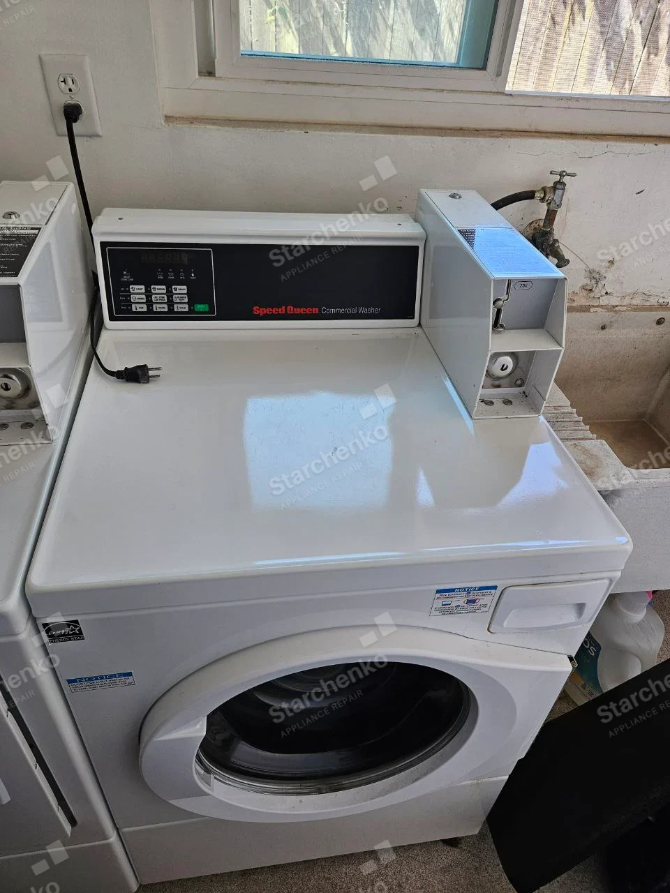 Speed Queen repair: Coin-operated front-load commercial washer with coin box and digital control panel.