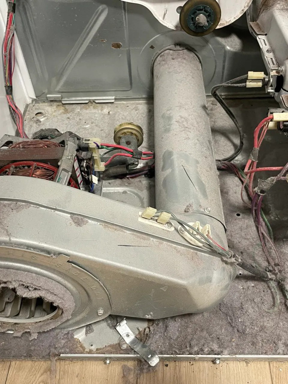 Dryer blower housing packed with lint, cover removed
