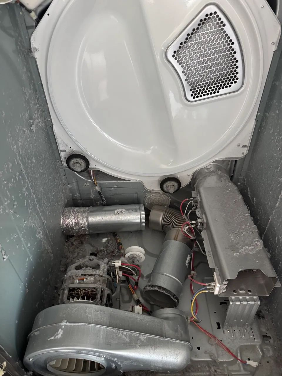 Dryer interior with the motor and blower covered in lint