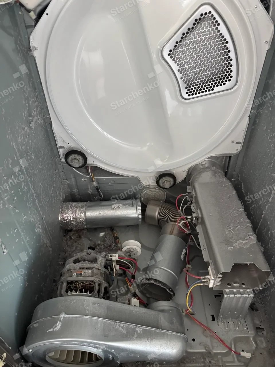 Samsung dryer interior with the motor and blower covered in lint