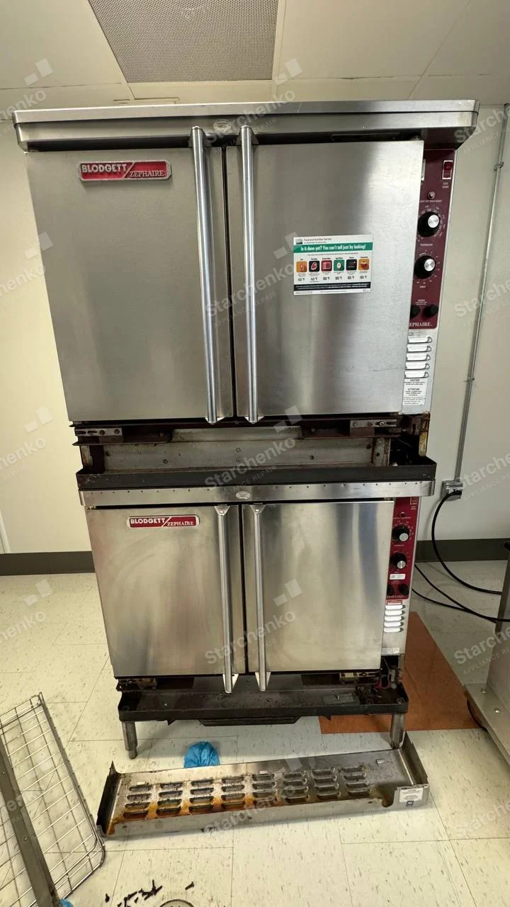 BLODGETT ZEPHAIRE badges on both decks of large commercial double oven, lower service panel removed.