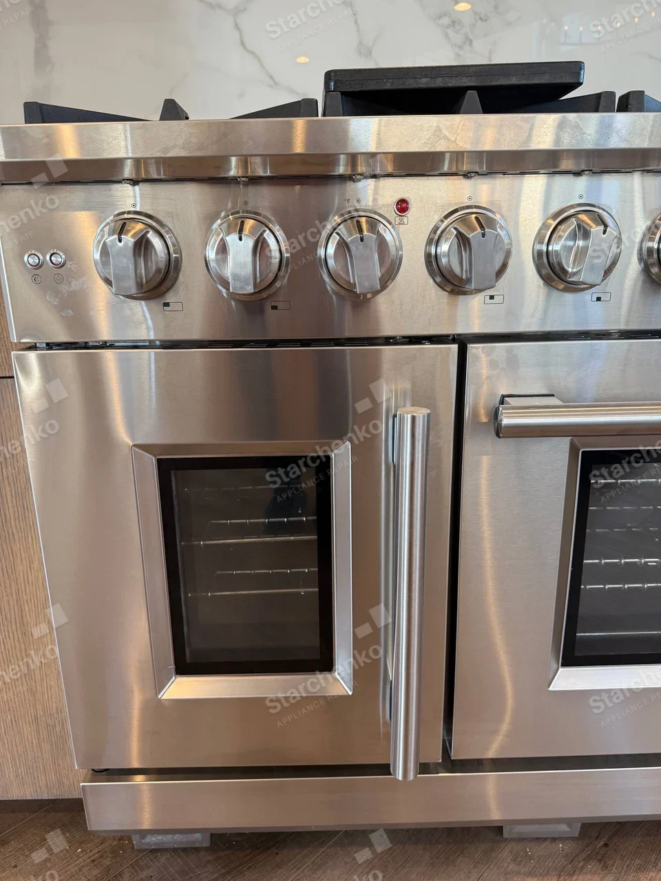 Kenmore repair: Close view of stainless gas range cooktop and two oven doors.