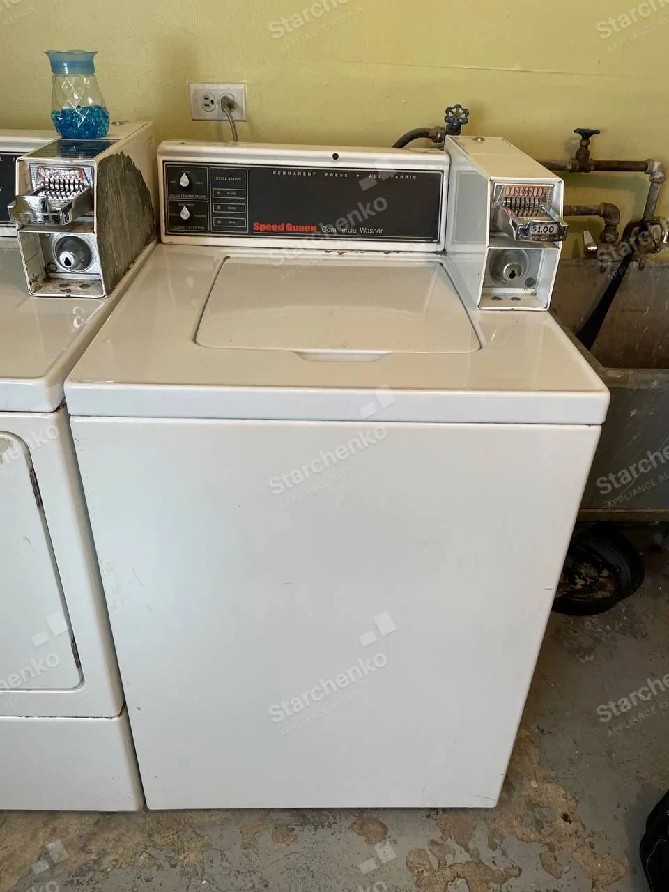 Speed Queen commercial top-load washer with two coin slides on its control console.