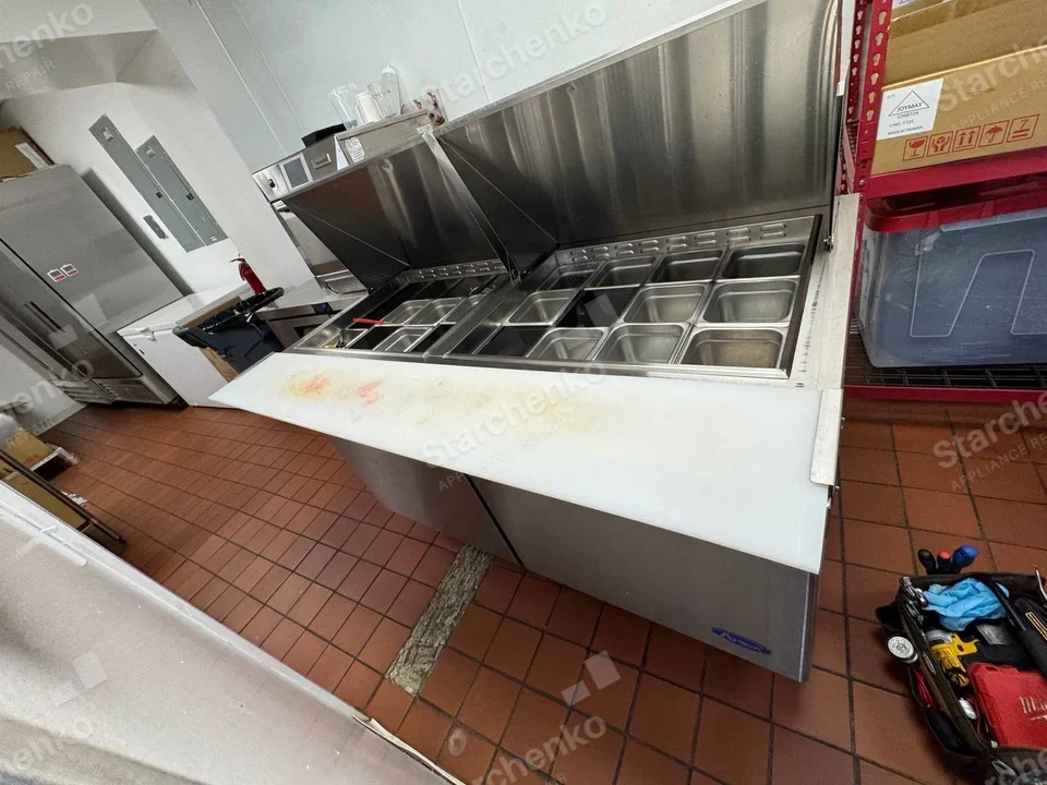 Atosa repair: Commercial refrigerated food-prep table with ingredient wells and hinged lids open.