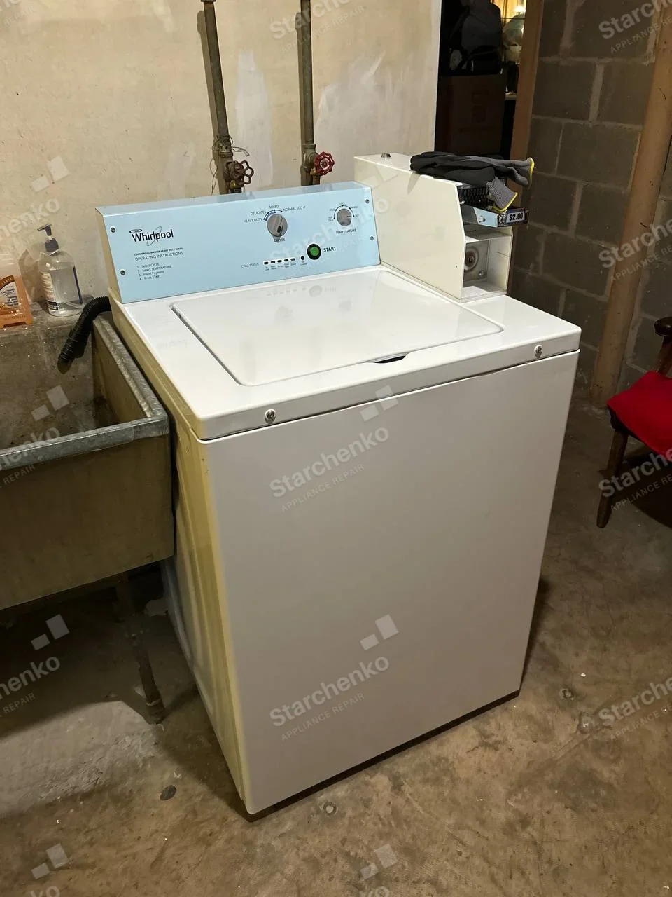 Whirlpool Commercial repair: Coin-operated top-load washer with coin housing and cycle controls.