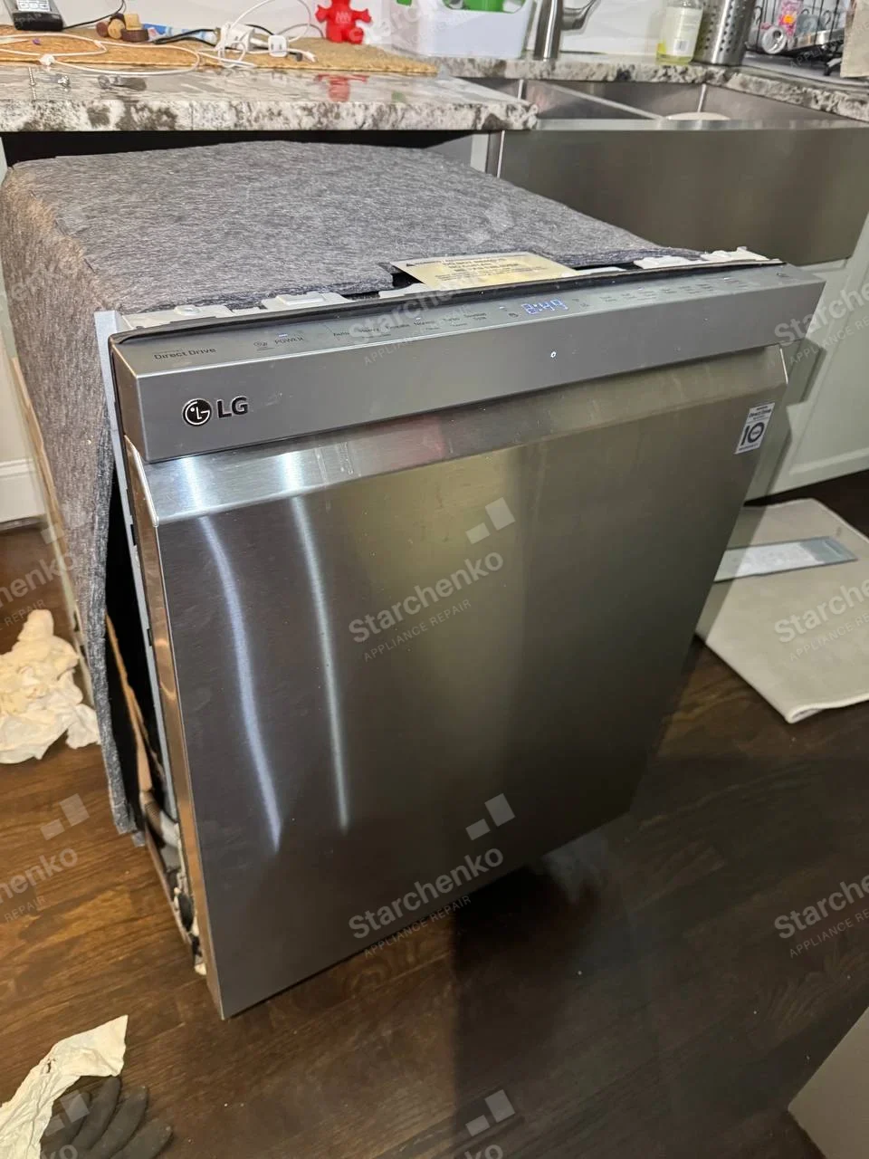 LG logo on upper-left front of dishwasher removed from cabinet.
